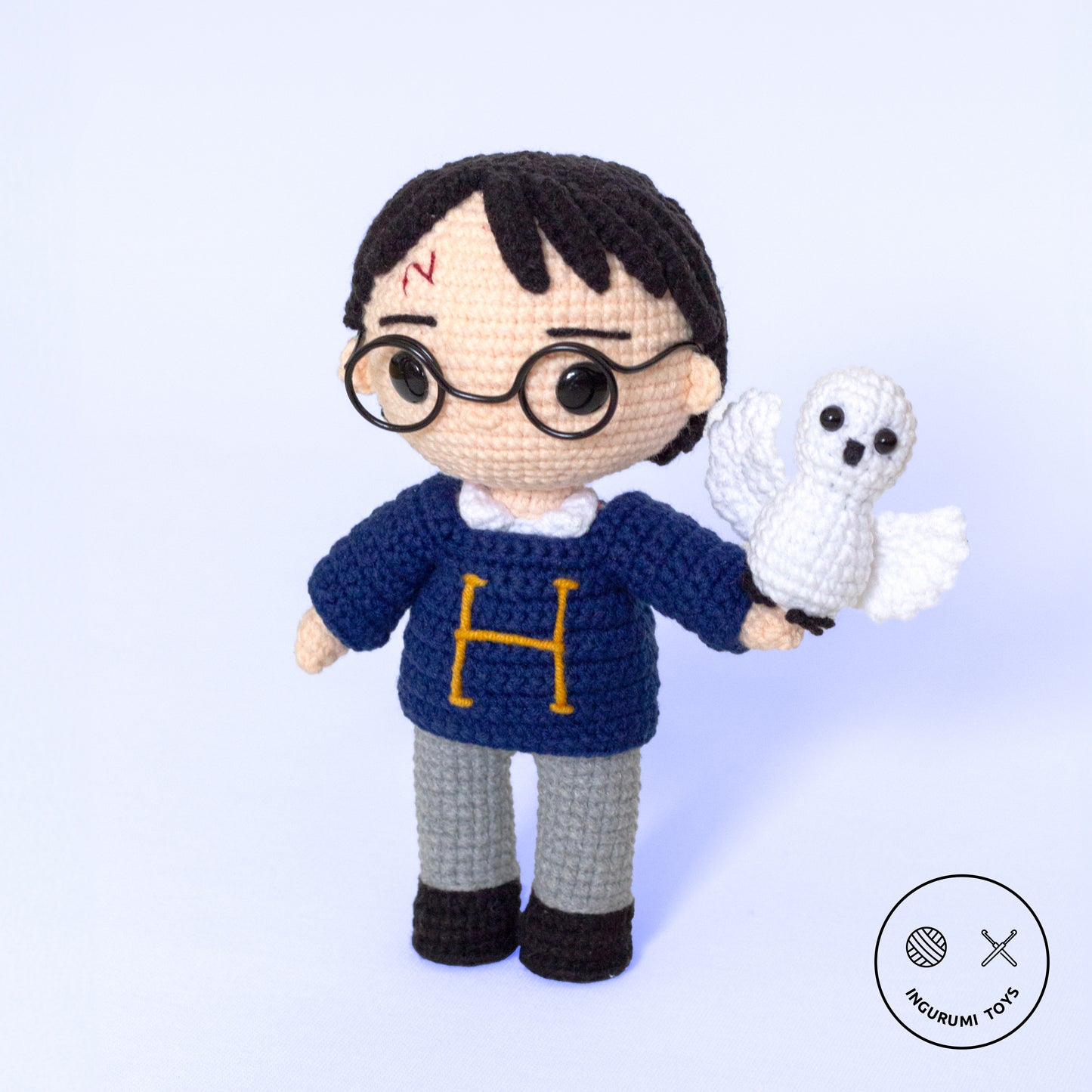 Harry Potter amigurumi crochet pattern featuring a toy in a blue sweater with an embroidered 'H' and a crocheted Hedwig owl