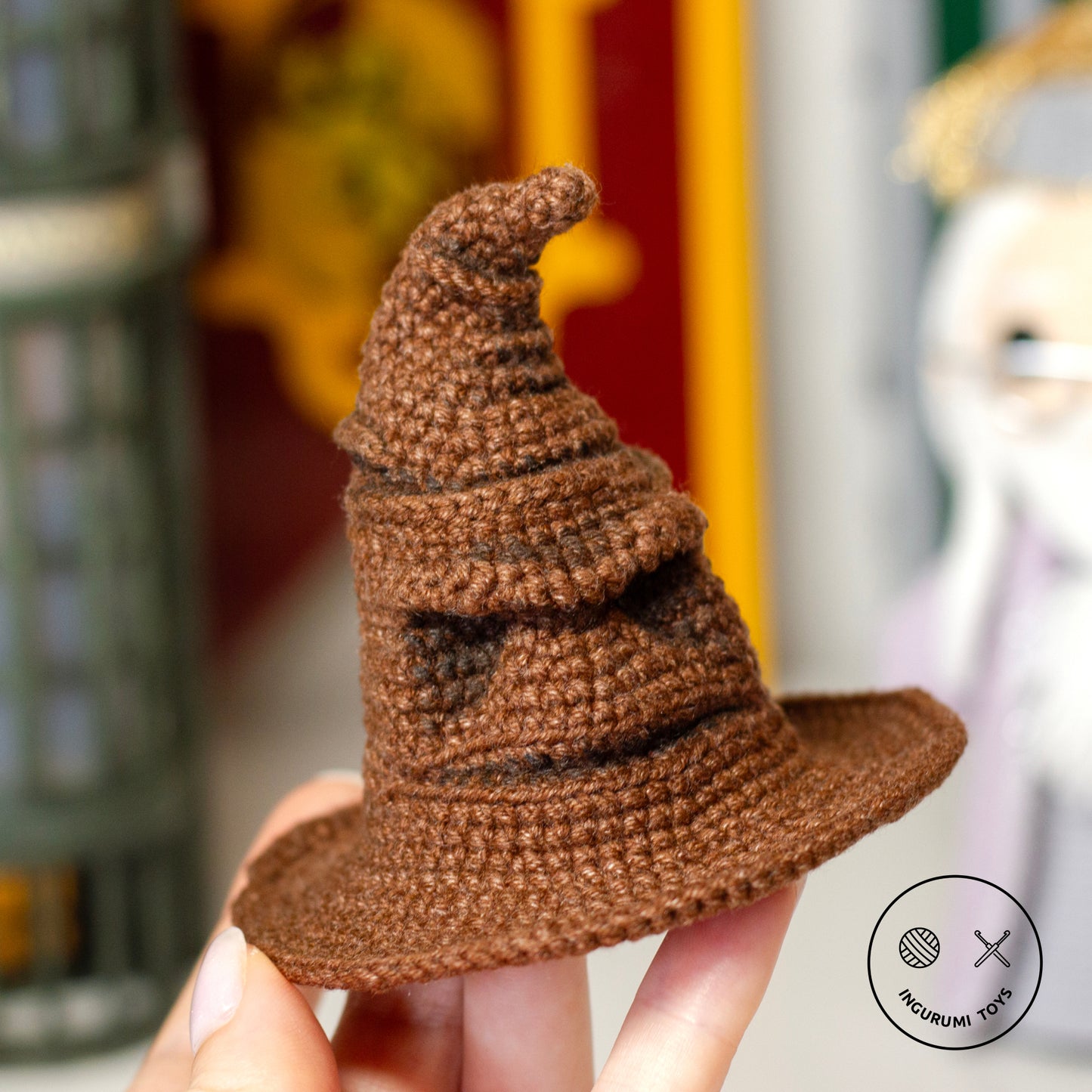 Amigurumi crochet toy of the Sorting Hat from Harry Potter, featuring detailed folds and a face, made with brown yarn