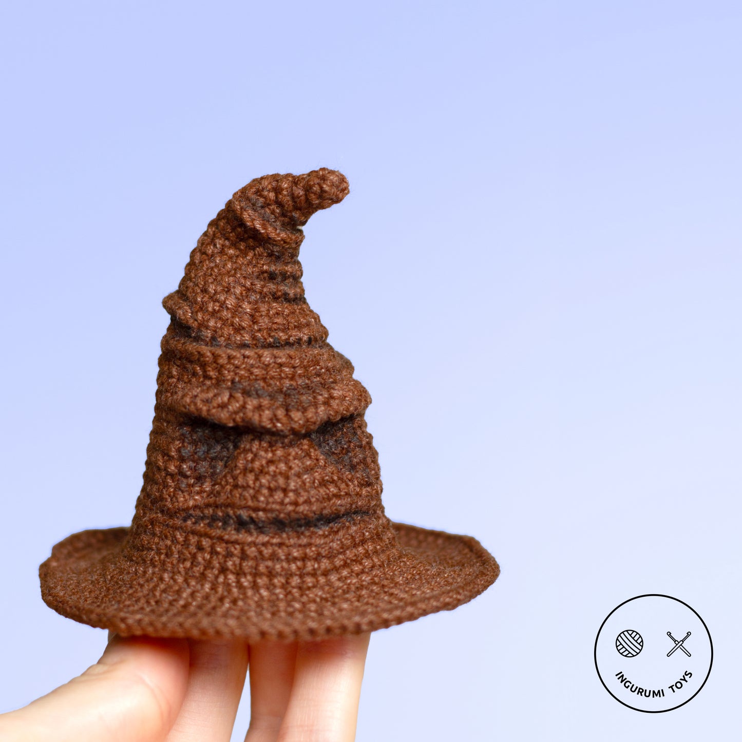 Amigurumi crochet toy of the Sorting Hat from Harry Potter, featuring detailed folds and a face, made with brown yarn