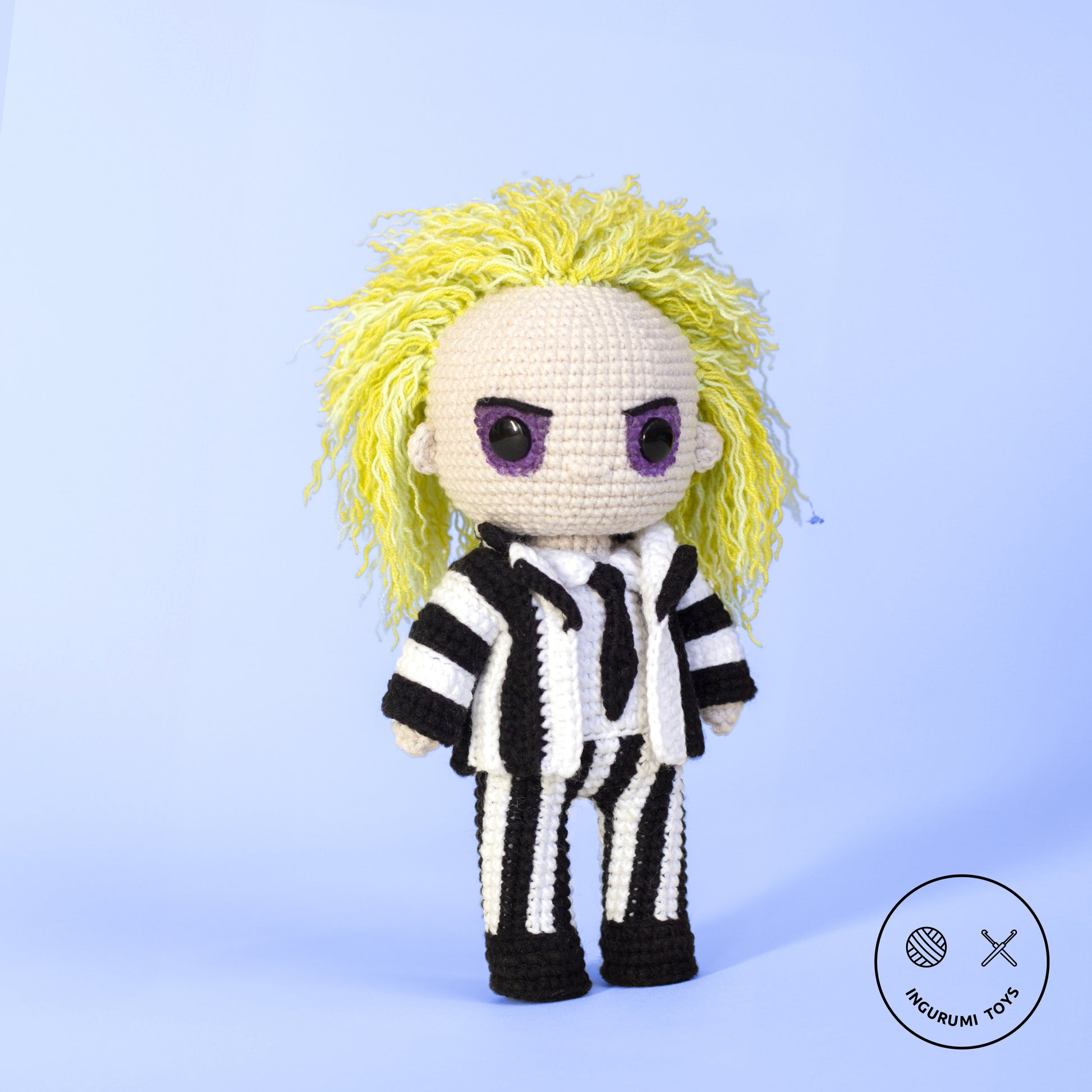 Amigurumi crochet toy of Beetlejuice with green hair and black-and-white striped suit