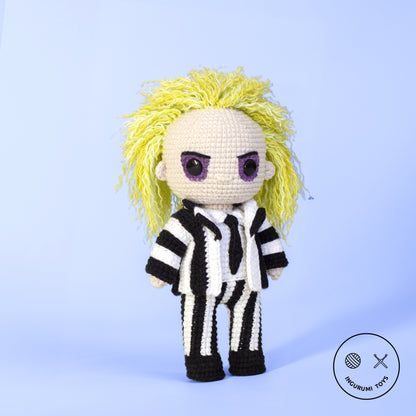 Amigurumi crochet toy of Beetlejuice with green hair and black-and-white striped suit