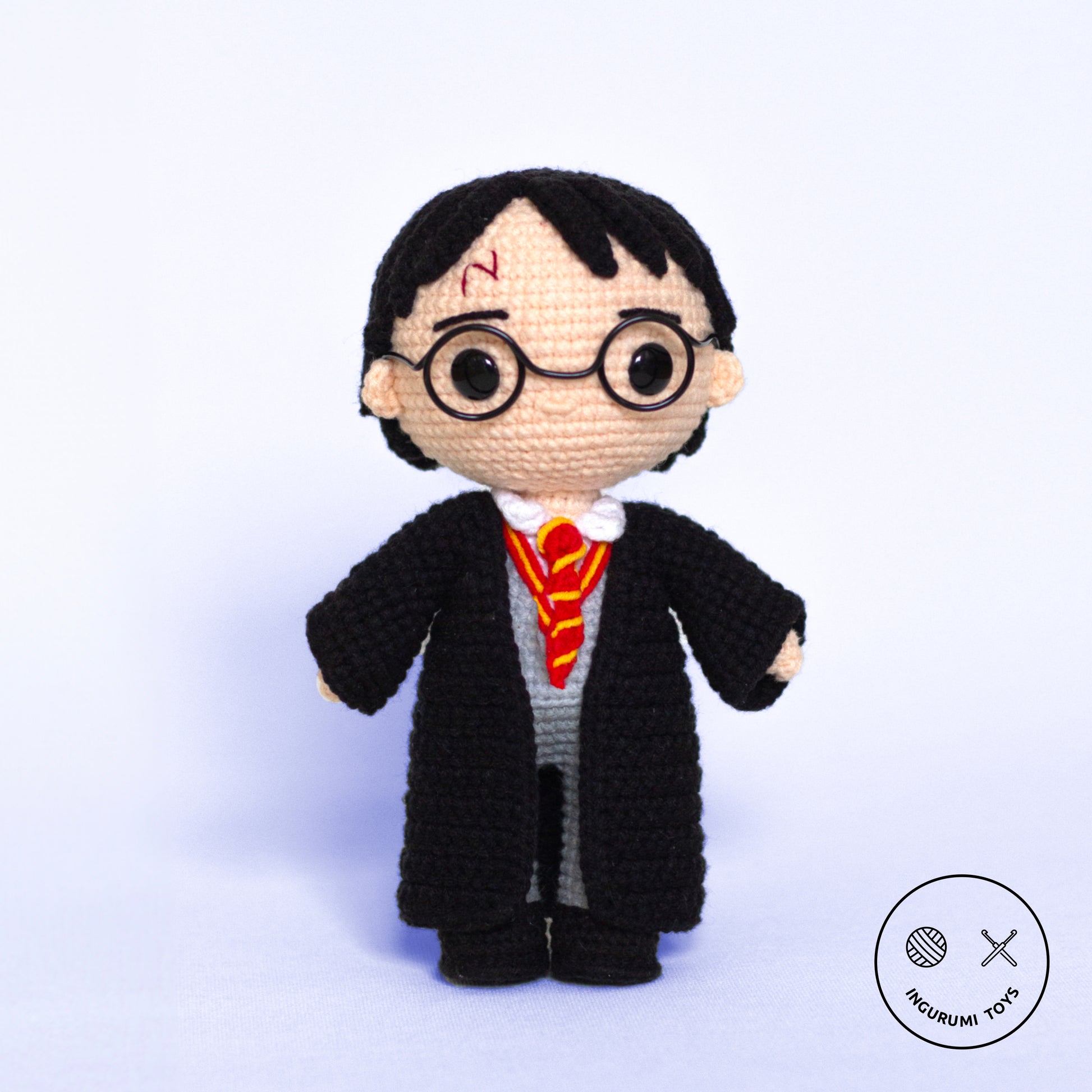 Harry Potter amigurumi crochet pattern – toy in black cloak with red and yellow tie and crocheted Hedwig owl