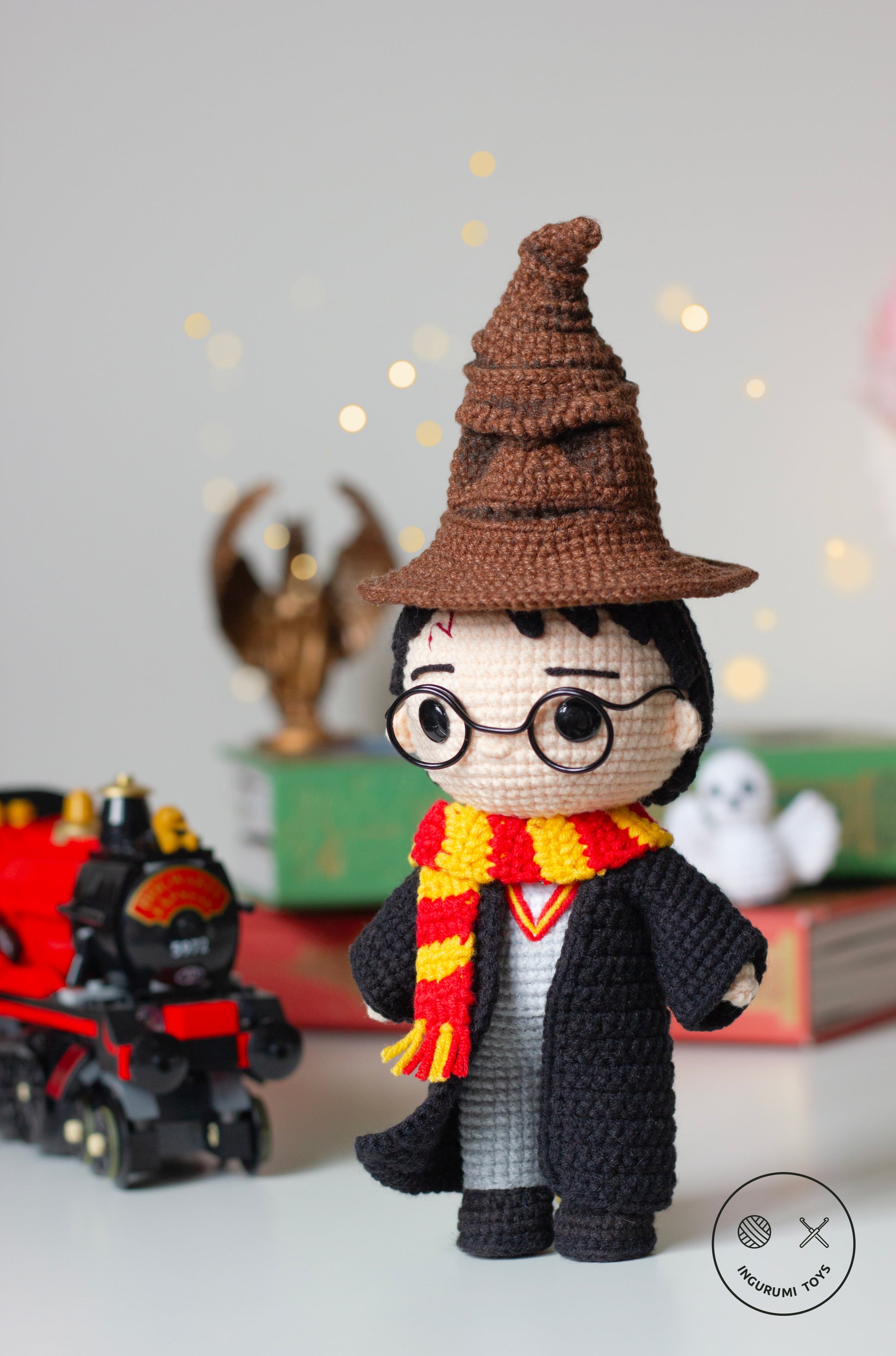 Harry Potter amigurumi crochet toy pattern in black cloak with red and yellow Gryffindor scarf, blue H letter sweater  and crocheted Hedwig owl. And the Sorting Hat crochet amigurumi pattern from Harry Potter, featuring detailed folds and a face, made with brown yarn